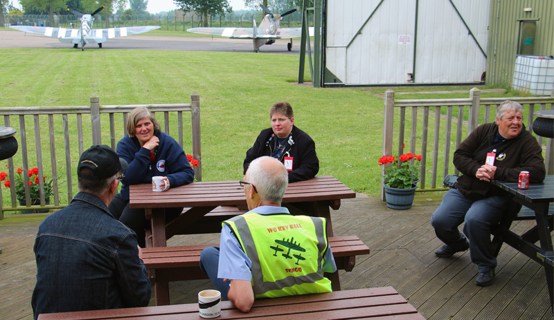 Simon, Caroline, Karen and Arthur chatting on the veranda outside the BBMF HQ with Warrant Officer Kev Ball, the BBMF Senior Engineering Officer.