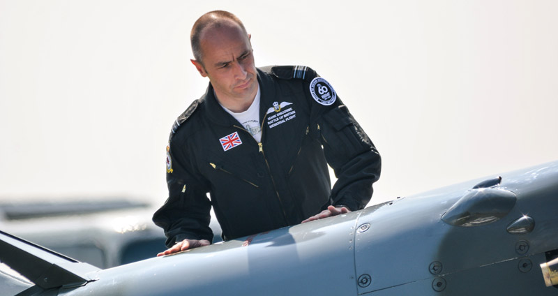 Sqn Ldr Mark ‘Disco’ Discombe carrying out his pre-flight external checks on Spitfire Mk Vb AB910