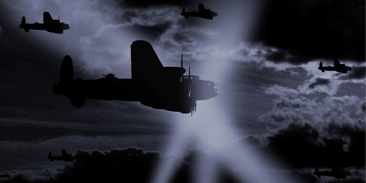 Lancasters in the bomber stream with enemy searchlights